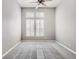 Spacious bedroom with gray carpet, ceiling fan, and a bright window with plantation shutters at 8300 Fairmount Dr # J105, Denver, CO 80247