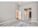A light grey bedroom with a view to the bathroom and kitchen, and a closet at 8300 Fairmount Dr # J105, Denver, CO 80247