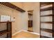 Custom walk-in closet with wood shelving and mirror at 8300 Fairmount Dr # J105, Denver, CO 80247