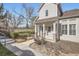 Charming home featuring a covered front porch, stone accents, and manicured landscaping, creating inviting curb appeal at 8300 Fairmount Dr # J105, Denver, CO 80247