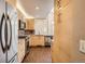 Modern kitchen featuring stainless steel appliances, granite countertops, and wood flooring at 8300 Fairmount Dr # J105, Denver, CO 80247