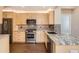 Modern kitchen boasting stainless steel appliances, granite countertops, and stylish backsplash at 8300 Fairmount Dr # J105, Denver, CO 80247