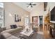 Spacious living room with soaring ceilings, fireplace, and an open layout to the dining area and kitchen at 8300 Fairmount Dr # J105, Denver, CO 80247