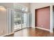 Hardwood floors and large sliding glass doors with shutters create a bright and inviting living space at 8300 Fairmount Dr # J105, Denver, CO 80247