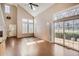 Bright living room featuring a fireplace, vaulted ceilings, large windows, and hardwood floors at 8300 Fairmount Dr # J105, Denver, CO 80247