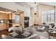 Open-concept living space with a fireplace, connecting the living room, dining area, and kitchen at 8300 Fairmount Dr # J105, Denver, CO 80247
