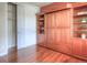 Functional bedroom featuring a built-in Murphy bed with shelving and a closet, optimizing space and storage at 8594 W Quarto Ave, Littleton, CO 80128