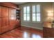 Cozy bedroom with a built-in Murphy bed and shelving, complemented by natural light from shuttered windows at 8594 W Quarto Ave, Littleton, CO 80128