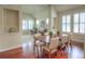 Dining area open to living room, boasting hardwood floors and natural light at 8594 W Quarto Ave, Littleton, CO 80128