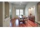 Sun-filled dining room with hardwood floors, large windows, and stylish furnishings create a cozy eating space at 8594 W Quarto Ave, Littleton, CO 80128