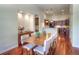 Open dining area with hardwood floors, built-in buffet, and modern furnishings with seating for up to eight at 8594 W Quarto Ave, Littleton, CO 80128
