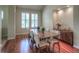 Well-lit dining area featuring hardwood floors, a large window, a display niche, and a dining table at 8594 W Quarto Ave, Littleton, CO 80128