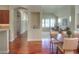 Open dining area featuring hardwood floors with views into living room and kitchen at 8594 W Quarto Ave, Littleton, CO 80128