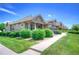Landscaped front yard and walkway leading to attractive townhomes at 8594 W Quarto Ave, Littleton, CO 80128
