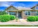 Charming home featuring manicured landscaping, stone accents, and a welcoming front porch at 8594 W Quarto Ave, Littleton, CO 80128
