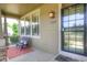 Charming front porch featuring seating, decorative pillows, and a covered entrance, adding curb appeal at 8594 W Quarto Ave, Littleton, CO 80128
