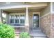 Inviting covered front porch with stone accents and a cozy seating area at 8594 W Quarto Ave, Littleton, CO 80128