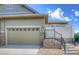 Two-car garage with stone accents and updated garage door at 8594 W Quarto Ave, Littleton, CO 80128