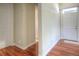 Bright hallway featuring beautiful hardwood floors and white doors and trim, creating a welcoming entrance at 8594 W Quarto Ave, Littleton, CO 80128