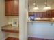 Eat-in kitchen featuring dark wood cabinetry, granite countertops, and wood flooring, offering a warm and inviting space at 8594 W Quarto Ave, Littleton, CO 80128