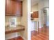 Kitchen featuring dark wood cabinetry, granite countertops, and hardwood floors, with archway to an adjacent room at 8594 W Quarto Ave, Littleton, CO 80128