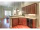 Functional kitchen with granite counters, stainless steel appliances, and ample cabinetry that flows into dining area at 8594 W Quarto Ave, Littleton, CO 80128