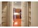 Inviting view of a kitchen with wood cabinets and modern appliances, seen through an open doorway at 8594 W Quarto Ave, Littleton, CO 80128