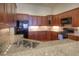 Kitchen with stainless steel appliances, granite countertops, warm wood cabinetry, and hardwood floors at 8594 W Quarto Ave, Littleton, CO 80128