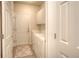 Functional laundry room with washer, dryer, and built-in cabinets, offering convenience and ample storage space at 8594 W Quarto Ave, Littleton, CO 80128