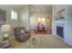 Cozy living room with hardwood floors, a fireplace, and an open-concept design at 8594 W Quarto Ave, Littleton, CO 80128
