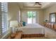 Bright main bedroom with tray ceiling, plush carpet, a dresser and sliding glass doors to a private patio at 8594 W Quarto Ave, Littleton, CO 80128