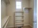 Well-organized walk-in closet with white shelving and hanging rods, providing ample storage space at 8594 W Quarto Ave, Littleton, CO 80128