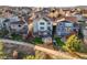 Aerial view of backyards featuring well-maintained lawns and patios in a neatly arranged neighborhood at 1271 Sky Rock Way, Castle Rock, CO 80109