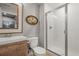 A remodeled bathroom featuring a subway tile shower, modern vanity, and wood-look mirror for a spa-like experience at 1271 Sky Rock Way, Castle Rock, CO 80109