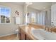 Bright bathroom with double sinks, a large mirror, and a window view of the neighborhood at 1271 Sky Rock Way, Castle Rock, CO 80109
