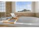 Luxurious soaking tub beneath a bright window; a perfect retreat for relaxation at 1271 Sky Rock Way, Castle Rock, CO 80109