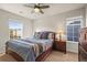 Comfortable bedroom with a ceiling fan, two windows for natural light, and complemented with a dark wooden furniture set at 1271 Sky Rock Way, Castle Rock, CO 80109