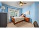 Charming bedroom with bright blue walls, a cozy bed, and natural light at 1271 Sky Rock Way, Castle Rock, CO 80109