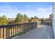 Spacious deck with wood railings offers scenic views of the surrounding green landscape and neighborhood at 1271 Sky Rock Way, Castle Rock, CO 80109