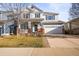 Charming two-story home with a manicured lawn, two-car garage, and inviting front porch at 1271 Sky Rock Way, Castle Rock, CO 80109