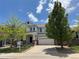 Inviting two-story home featuring a covered front porch and attached two-car garage, enhanced by mature trees at 1271 Sky Rock Way, Castle Rock, CO 80109
