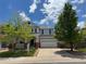 Inviting two-story home featuring a covered front porch and attached two-car garage, enhanced by mature trees at 1271 Sky Rock Way, Castle Rock, CO 80109
