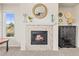 Fireplace with stone surround, decorative mantel, and a bright window showcasing natural light at 1271 Sky Rock Way, Castle Rock, CO 80109