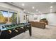 Recreation room with foosball table and couches, perfect for entertaining guests and enjoying the outdoors at 1271 Sky Rock Way, Castle Rock, CO 80109