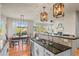 Open kitchen featuring granite countertops, a breakfast bar, and modern pendant lighting fixtures at 1271 Sky Rock Way, Castle Rock, CO 80109