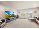 Spacious living room with large screen TV, piano, and a window providing natural light at 1271 Sky Rock Way, Castle Rock, CO 80109