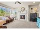 Living room showcasing a cozy fireplace, comfortable seating, and a large window with scenic outdoor views at 1271 Sky Rock Way, Castle Rock, CO 80109