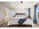 Well-lit main bedroom featuring a tray ceiling and windows overlooking the neighborhood at 1271 Sky Rock Way, Castle Rock, CO 80109