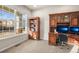 Cozy home office with built-in wooden bookcase, a desk, dual monitors, and natural light at 1271 Sky Rock Way, Castle Rock, CO 80109