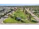 Aerial view of neighborhood park, highlighting lush greenery, walking paths, and playground equipment in a Gathering-friendly setting at 5640 Niagara St, Commerce City, CO 80022